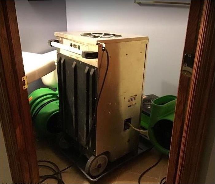 SERVPRO drying equipment in water damaged bathroom