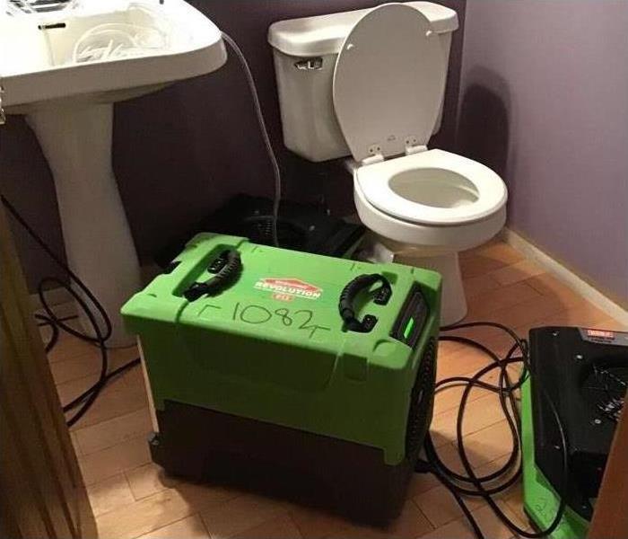 One of our industrial air movers and dehumidifiers drying this bathroom after a water damage disaster